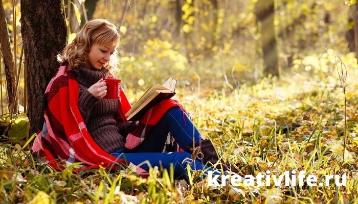Девушка читает книгу осенью